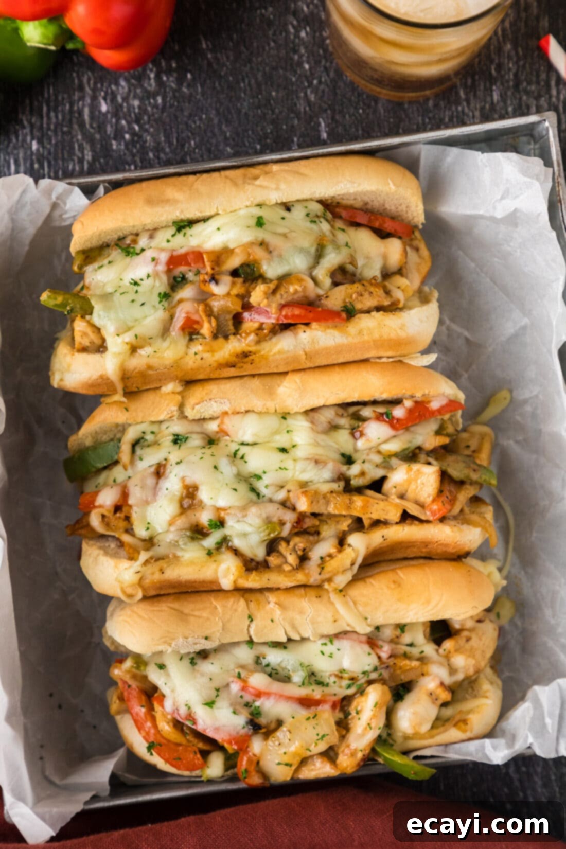 Philly Chicken Cheesesteak 3 Three Chicken Philly Cheesesteaks arranged in a sleek metal serving tray, highlighting the golden-brown buns and generous fillings.