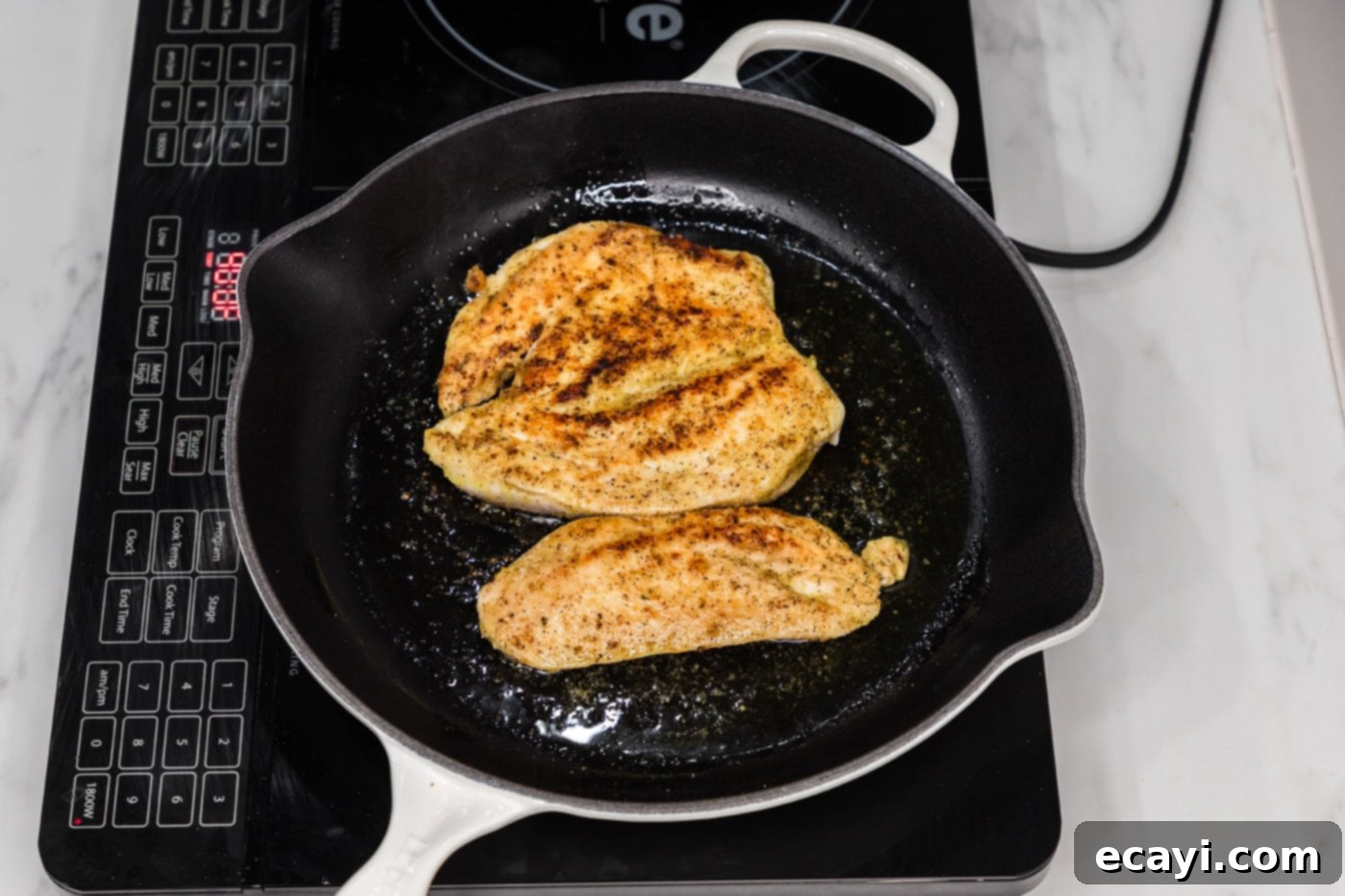 Philly Chicken Cheesesteak 6 Searing a seasoned chicken breast to a perfect golden brown in a hot skillet.