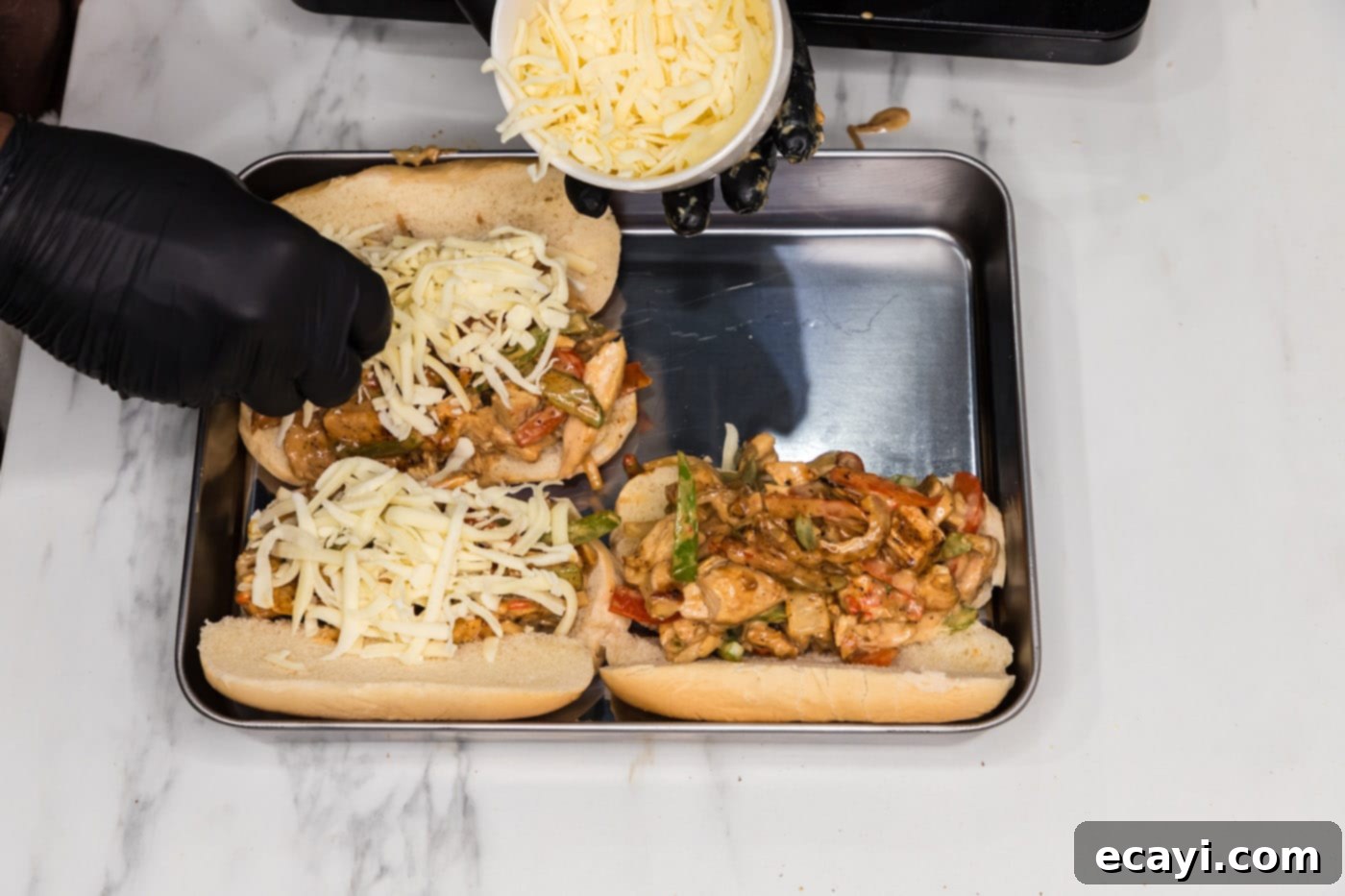 Philly Chicken Cheesesteak 10 Delicious chicken philly cheesesteak filling topped with shredded mozzarella cheese, ready for the oven.
