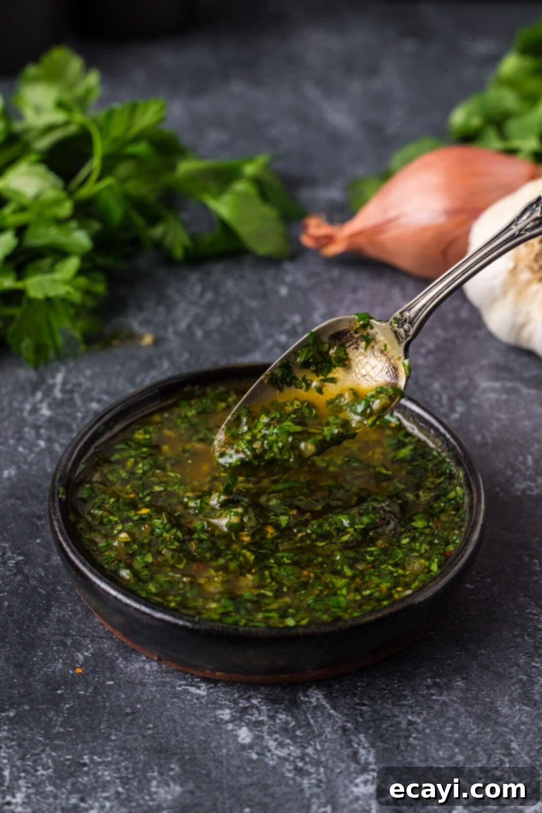Chimichurri Sauce 8 Spoon drizzling Chimichurri into a bowl, showcasing its fresh texture