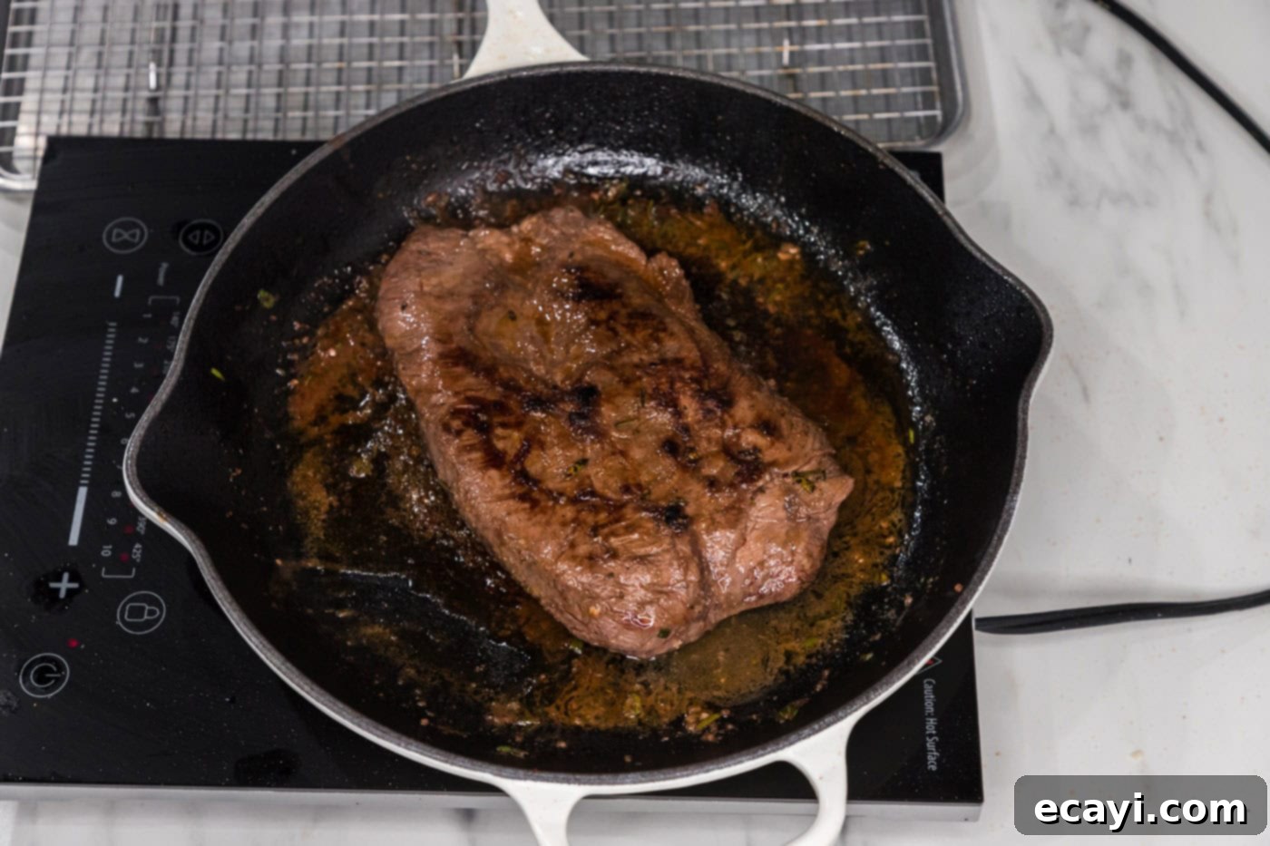 The Butcher's Secret Steak 8 seared cooked flat iron steak in a skillet