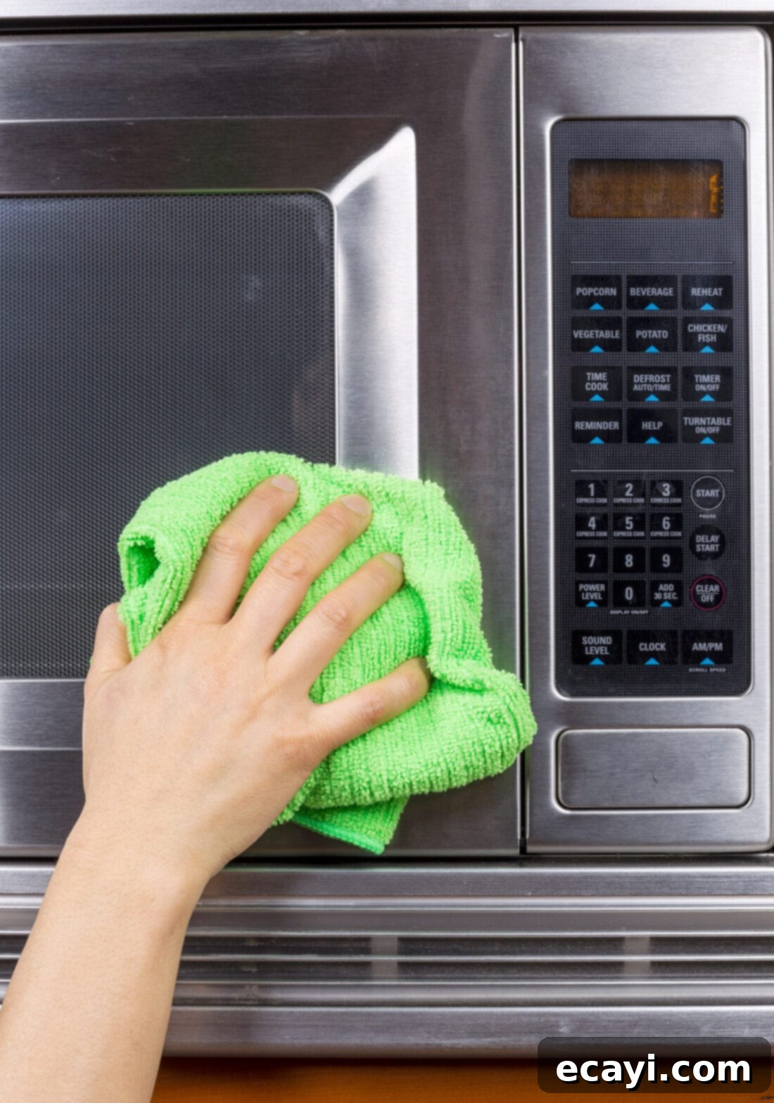 Effortless Microwave Shine 2 A person cleaning the inside of a microwave oven
