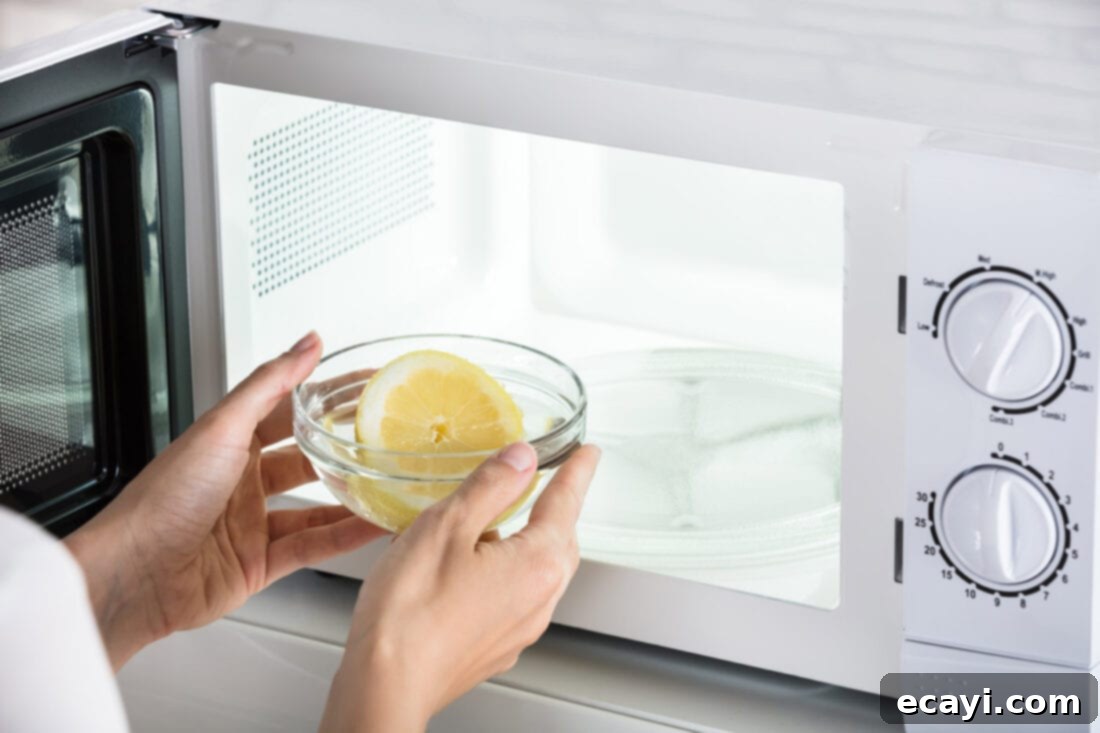 Effortless Microwave Shine 4 Half a lemon on a plate inside a microwave