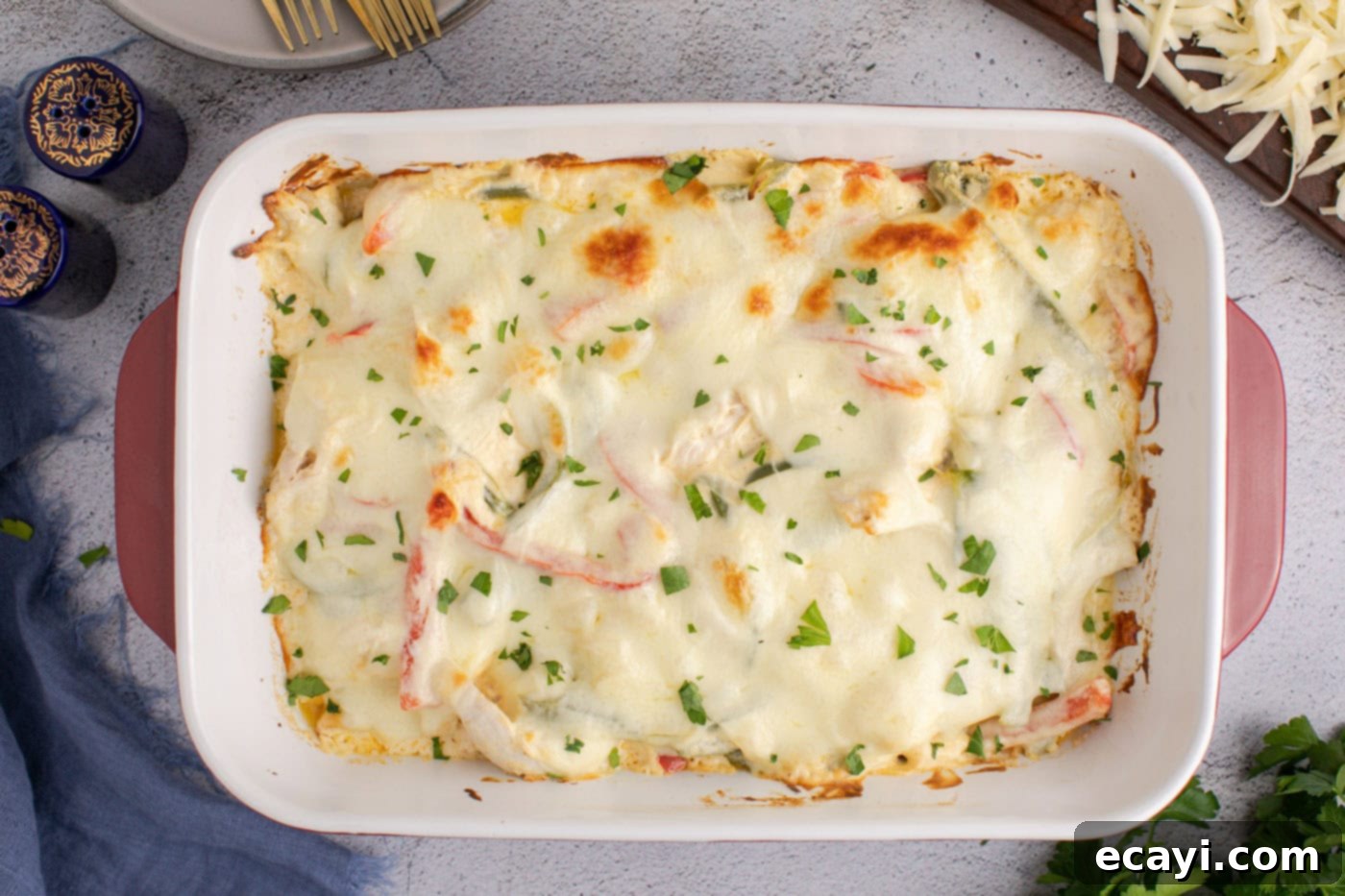 Cheesy Philly Chicken Bake 12 bubbly chicken philly cheesesteak casserole with chopped parsley as garnish