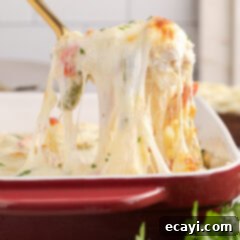 Cheesy Philly Chicken Bake 14 Spoonful of Philly Chicken Cheesesteak Casserole being lifted up from the casserole dish