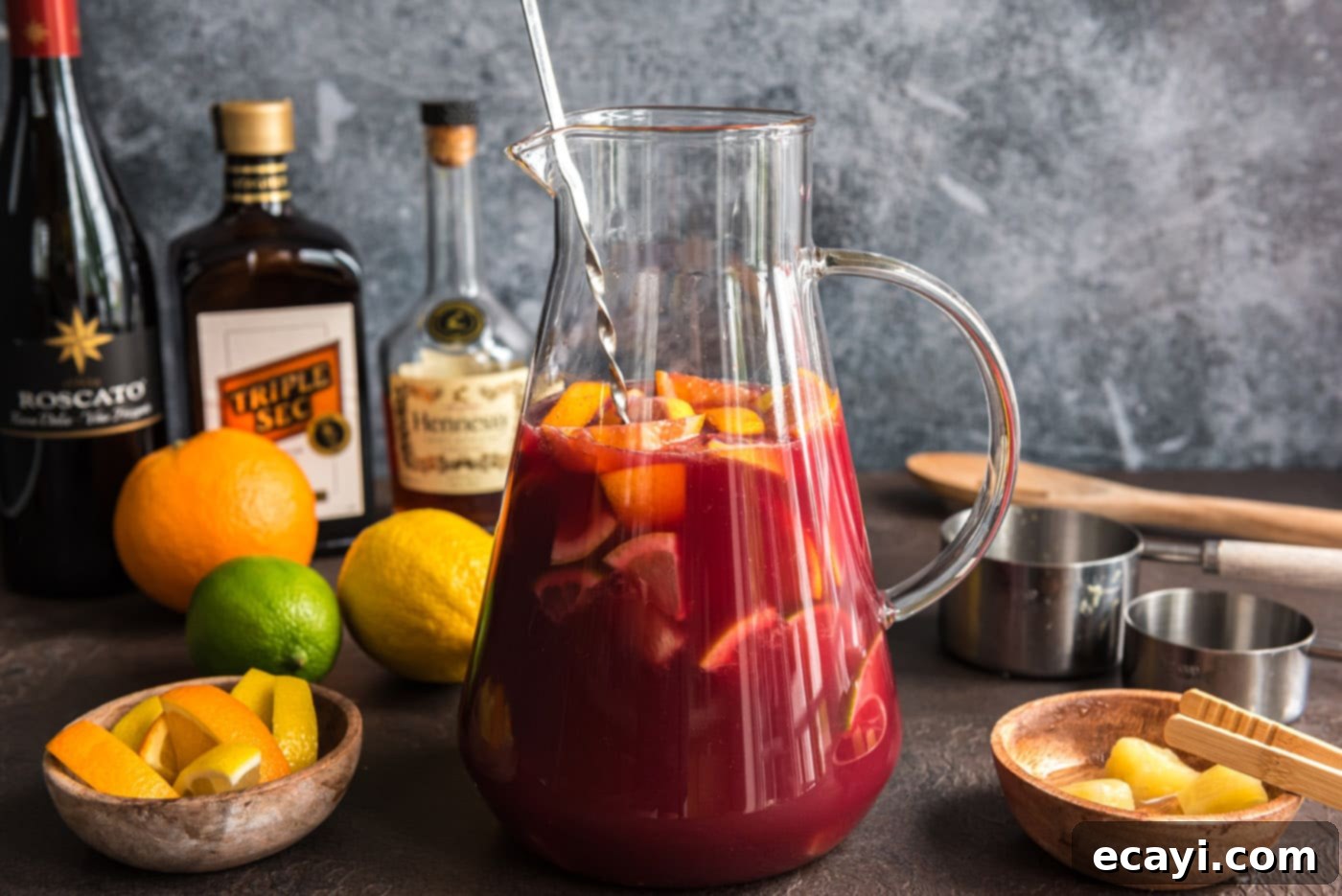 Mexican Fiesta Sangria 11 Stirring the Mexican sangria in a pitcher after combining all ingredients, prior to chilling