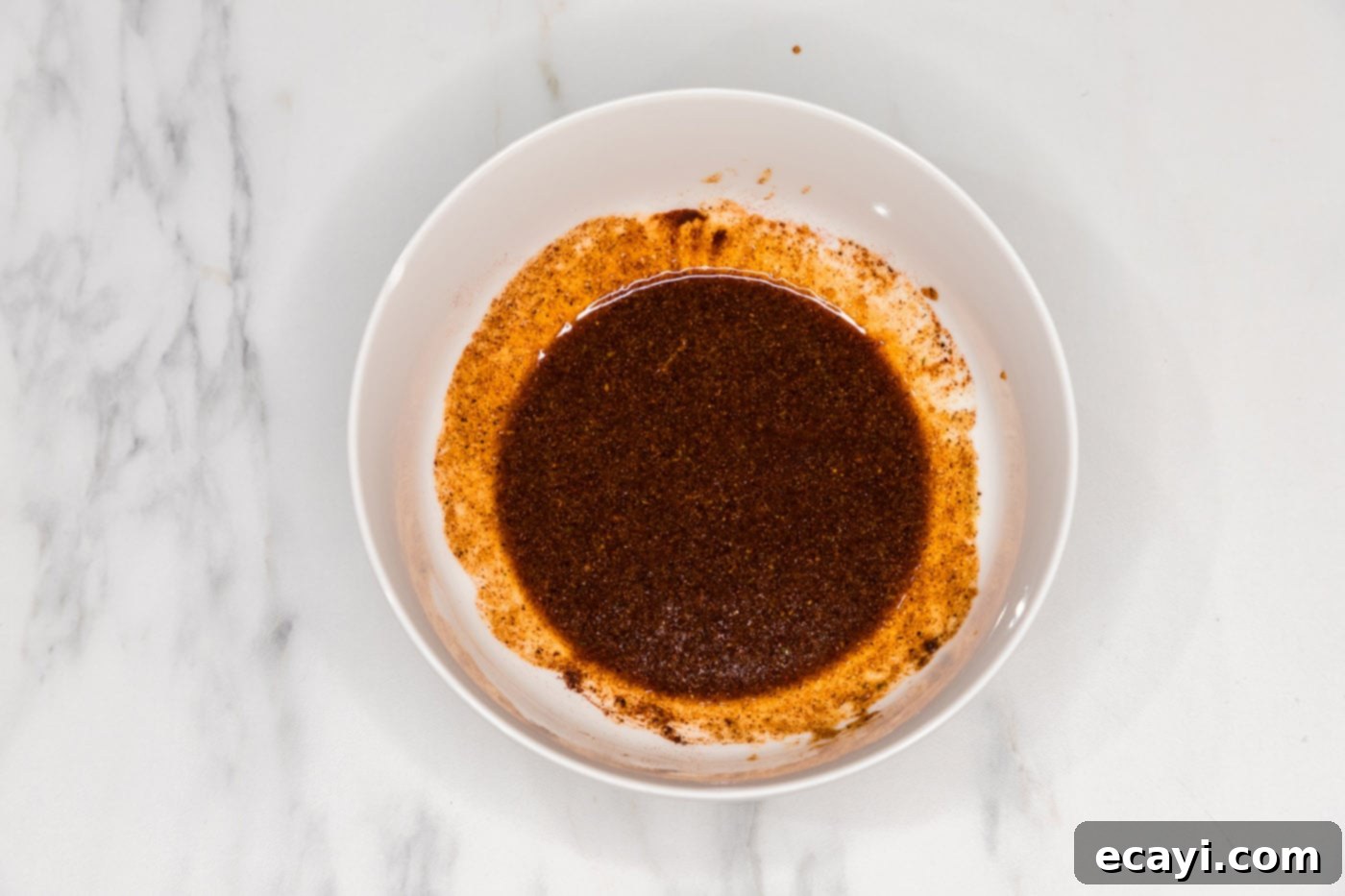 Down-Home Country Ribs 5 ribs wet rub in a bowl, showing the prepared spice mixture