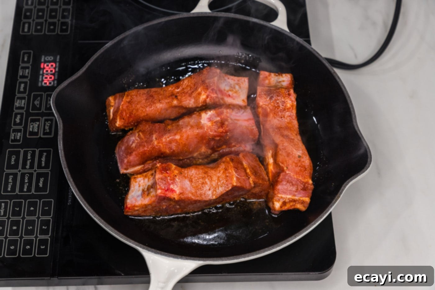 Down-Home Country Ribs 8 searing ribs in a skillet, showing the browning process
