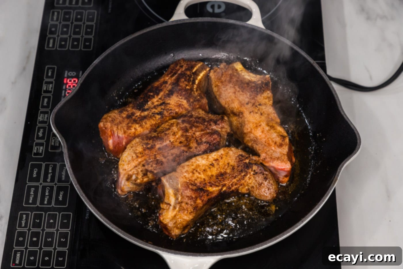 Down-Home Country Ribs 9 seared pork ribs in a skillet, displaying the beautifully browned meat