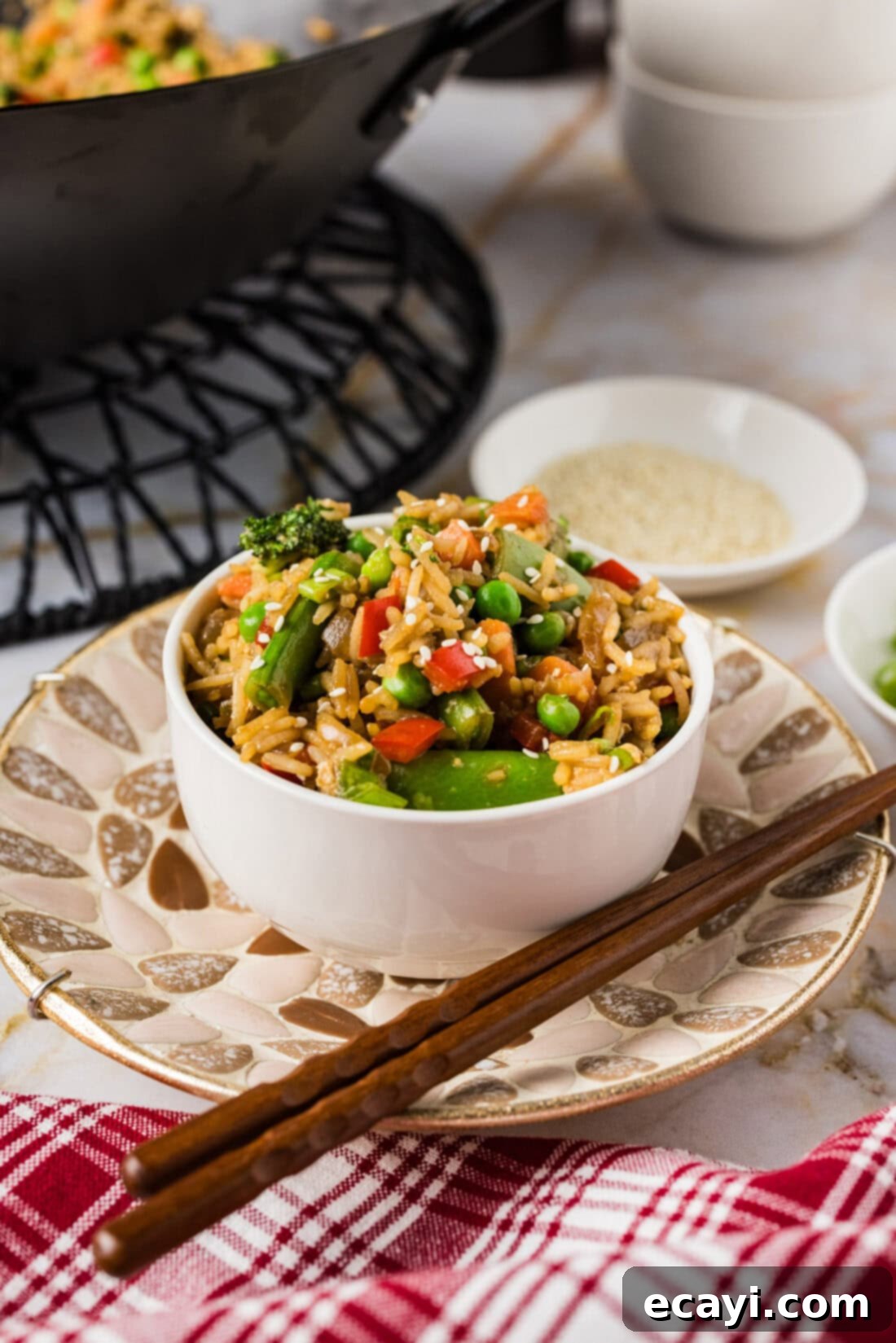 Garden Medley Fried Rice 2 Bowl of Vegetable Fried Rice with chopsticks on the side, highlighting fresh vegetables and perfectly cooked rice.