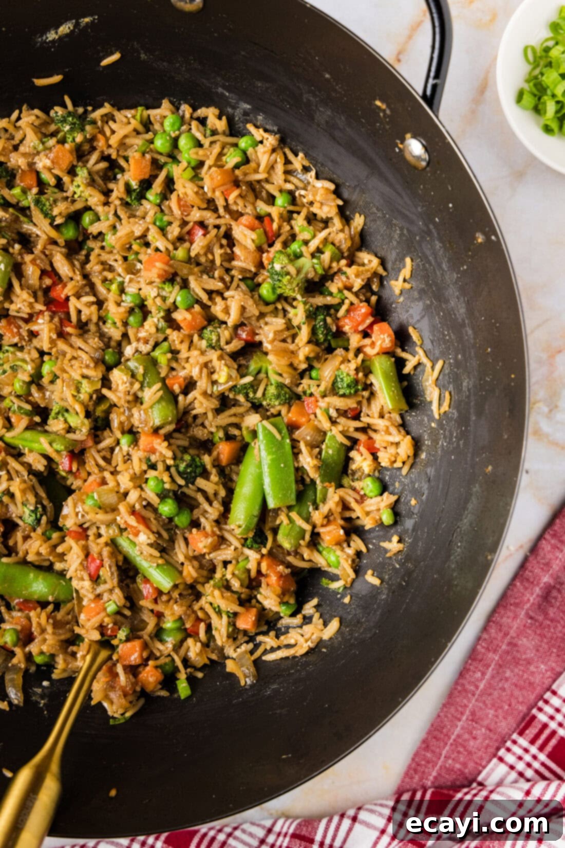 Garden Medley Fried Rice 5 Close up photo of a large wok filled with freshly made Vegetable Fried Rice, showcasing the fluffy rice and colorful vegetables.