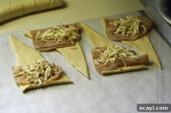 Step-by-step: adding turkey and cheese to crescents for roll ups. Adding turkey and cheese to crescent dough triangles