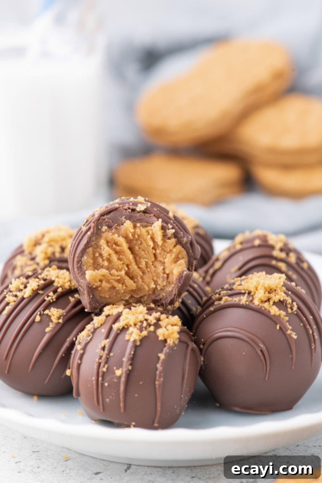 Peanut Butter Truffle Bites 12 Nutter Butter Balls arranged artfully on a white plate with a glass of milk in the background