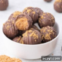 Peanut Butter Truffle Bites 13 A bowl of Nutter Butter Balls with one taken a bite out of, showing the creamy peanut butter filling
