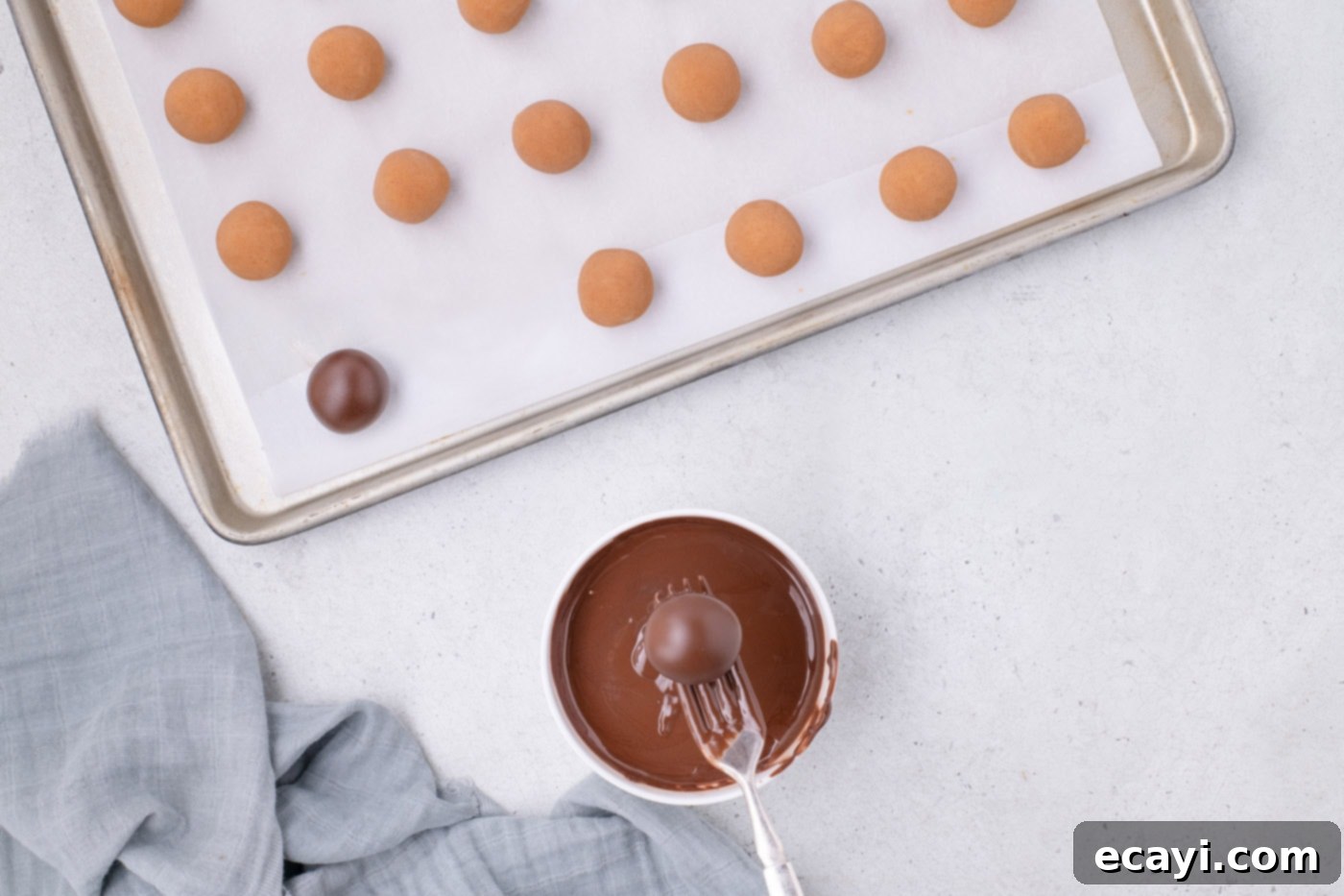 Peanut Butter Truffle Bites 9 A Nutter Butter cookie ball being dipped into melted chocolate with a fork