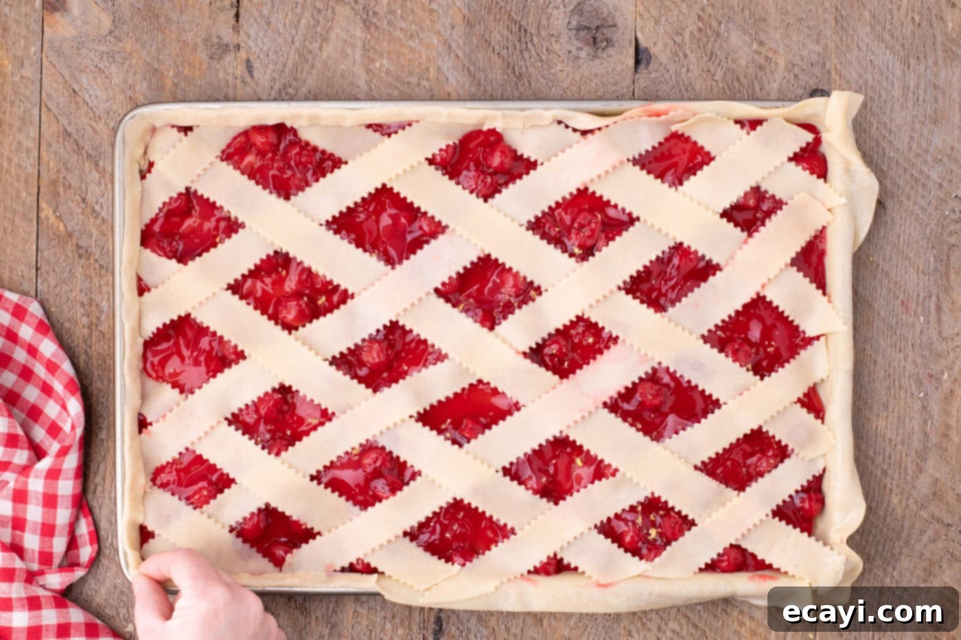 Sheet Pan Cherry Pie 15 pinching seams of pie crust together to seal edges of cherry slab pie