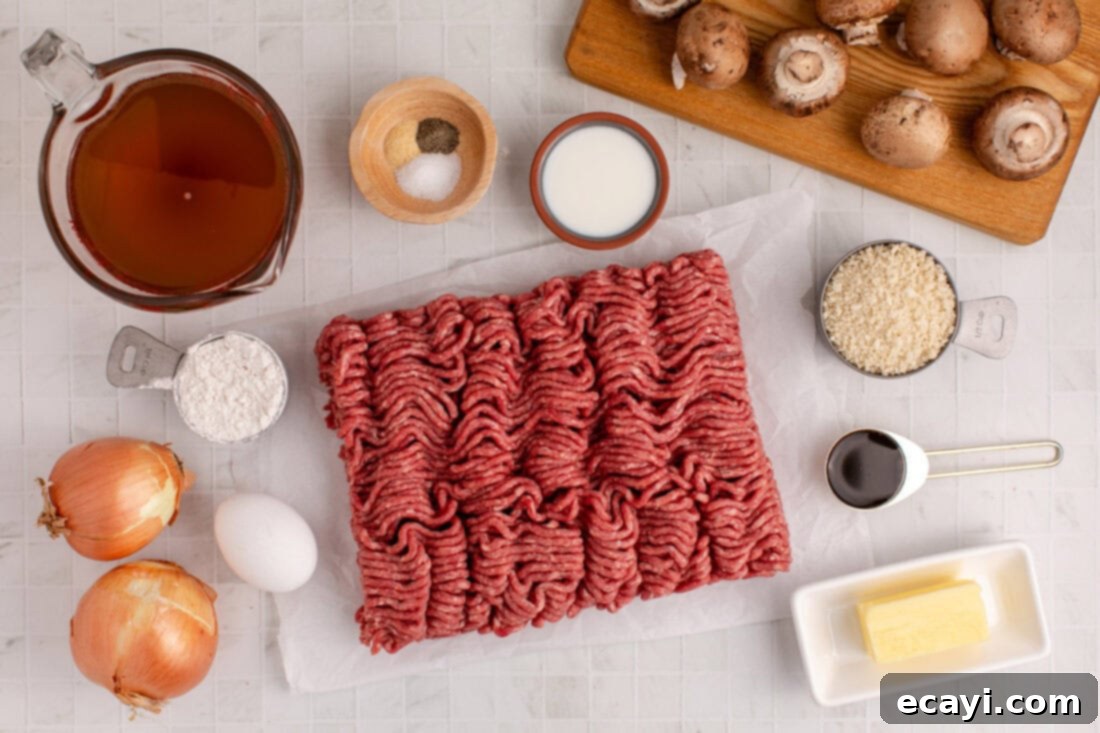 Hearty Salisbury Steak Meatballs 4 A vibrant display of fresh ingredients laid out, including ground beef, onions, mushrooms, butter, and spices, all essential for Salisbury Steak Meatballs.