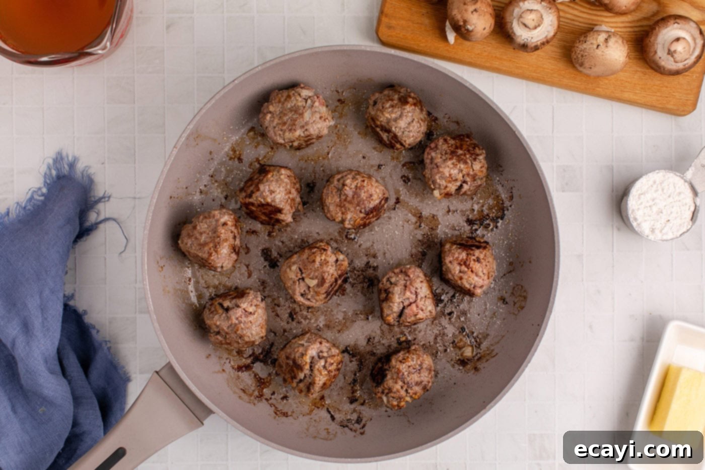Hearty Salisbury Steak Meatballs 8 meatballs sizzling and browning in a large skillet