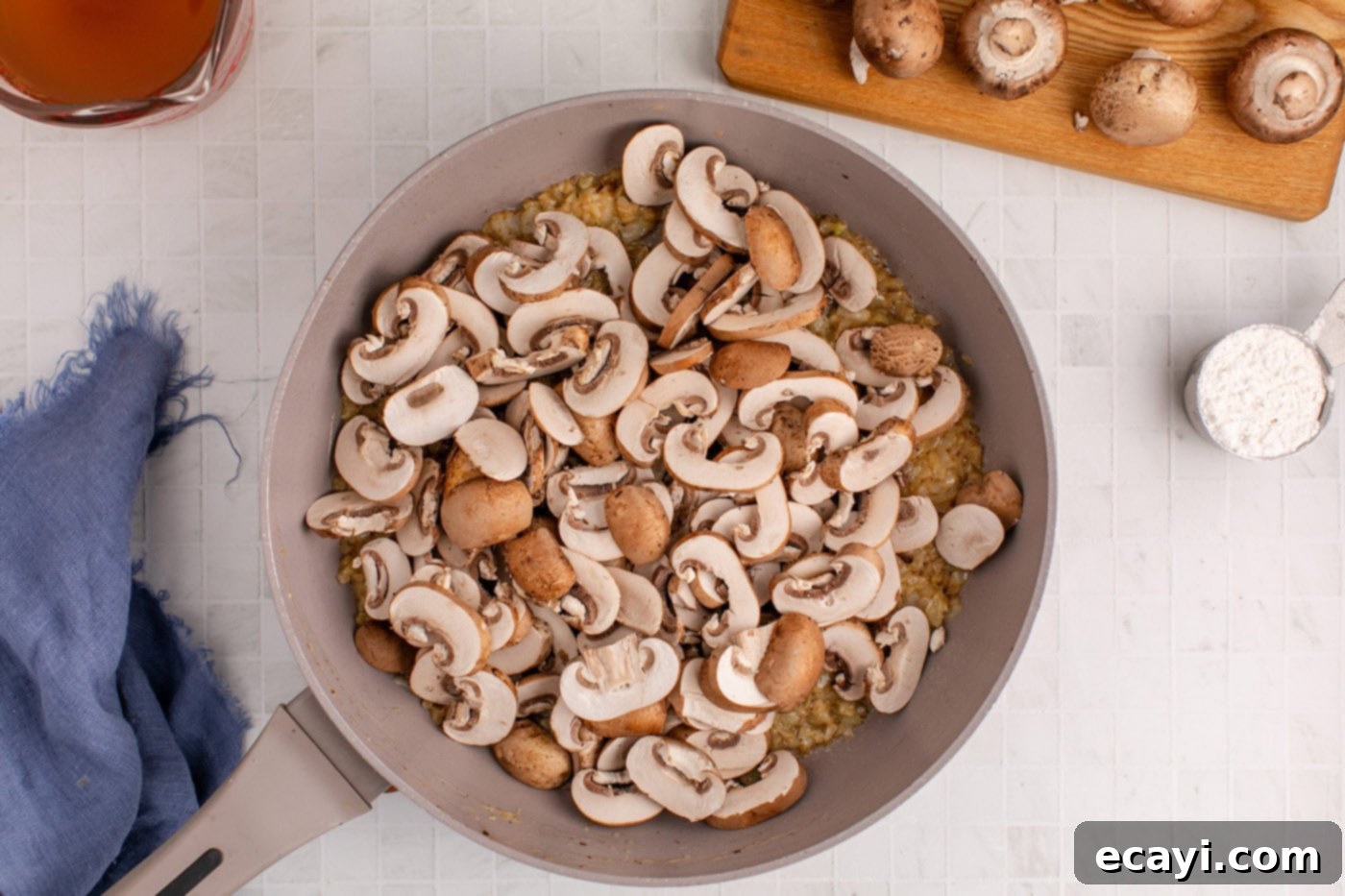 Hearty Salisbury Steak Meatballs 10 sliced mushrooms added to the skillet with sauteed onion, ready to cook down