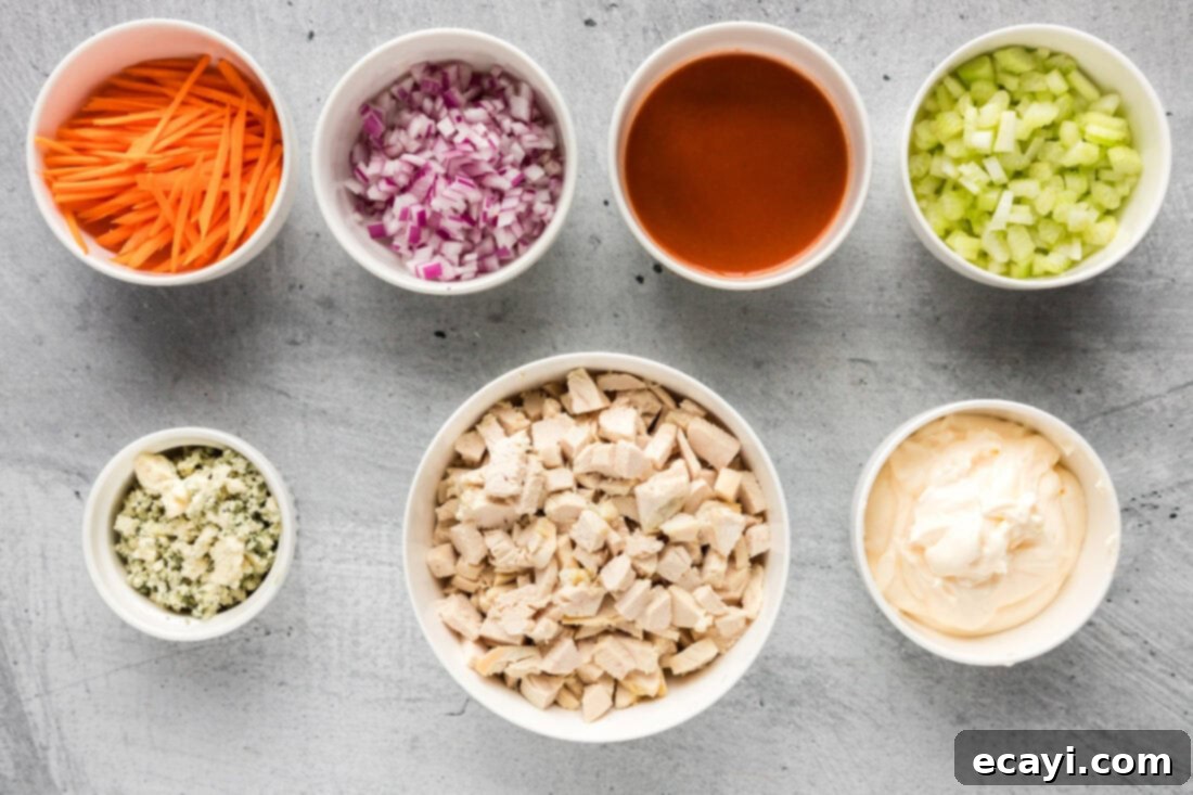 Fiery Buffalo Chicken Bowl 4 All ingredients laid out for making Buffalo Chicken Salad: cooked chicken, celery, carrots, red onion, hot sauce, and mayonnaise
