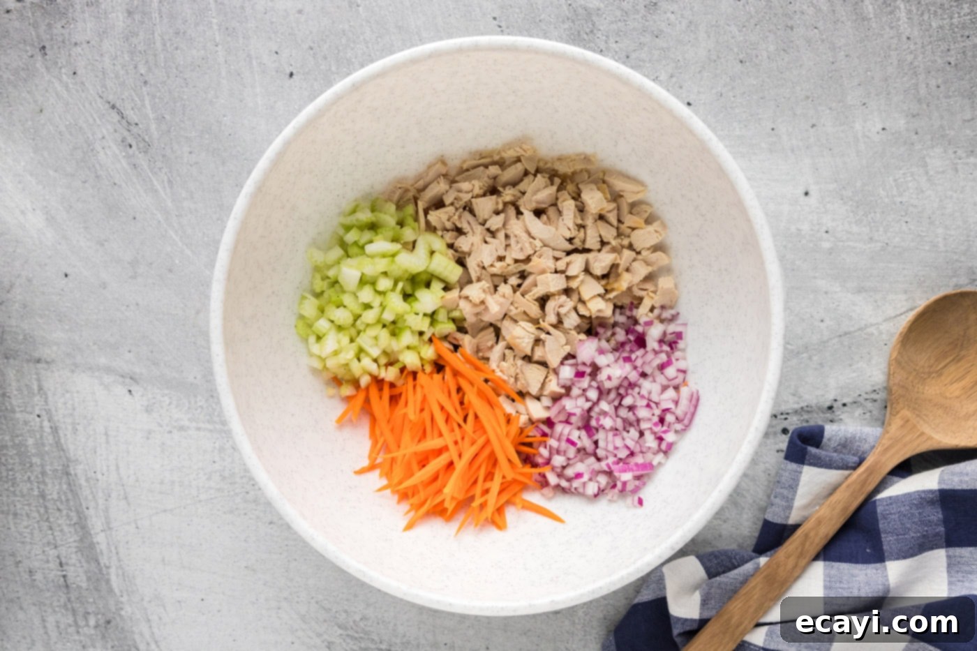 Fiery Buffalo Chicken Bowl 5 chopped chicken, celery, onion, and carrots in a mixing bowl, ready for dressing