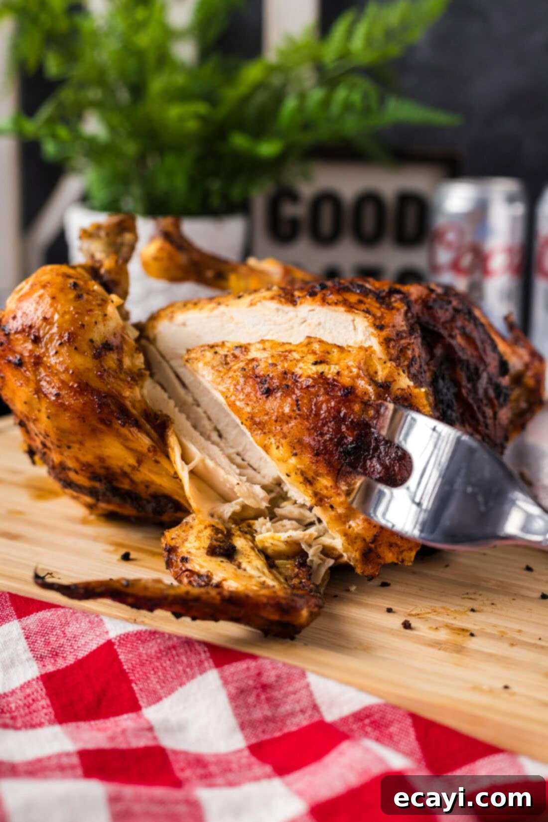 Juicy Beer-Infused Roasted Chicken 3 Piece of Beer Can Chicken being removed by a meat fork