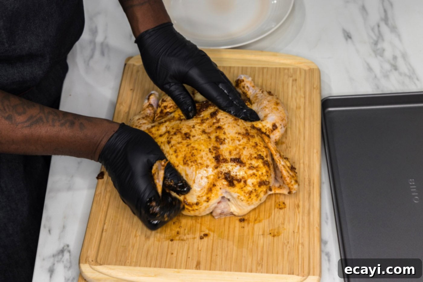 Juicy Beer-Infused Roasted Chicken 7 rubbing oil and seasonings over whole chicken