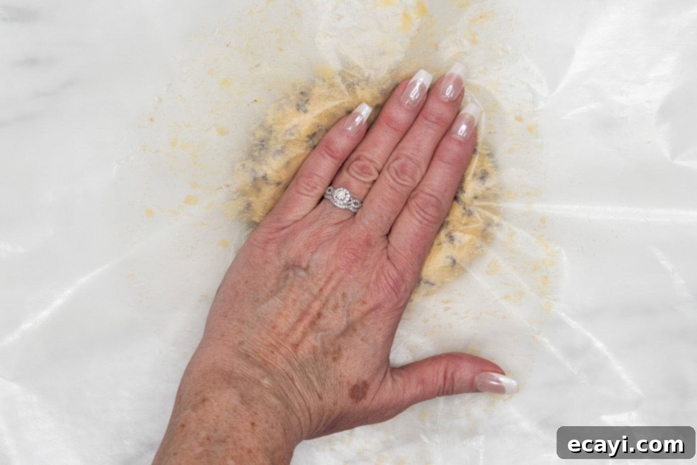 Chocolate Chip Cookie Mountain 7 hand flattening cookie dough ball with wax paper