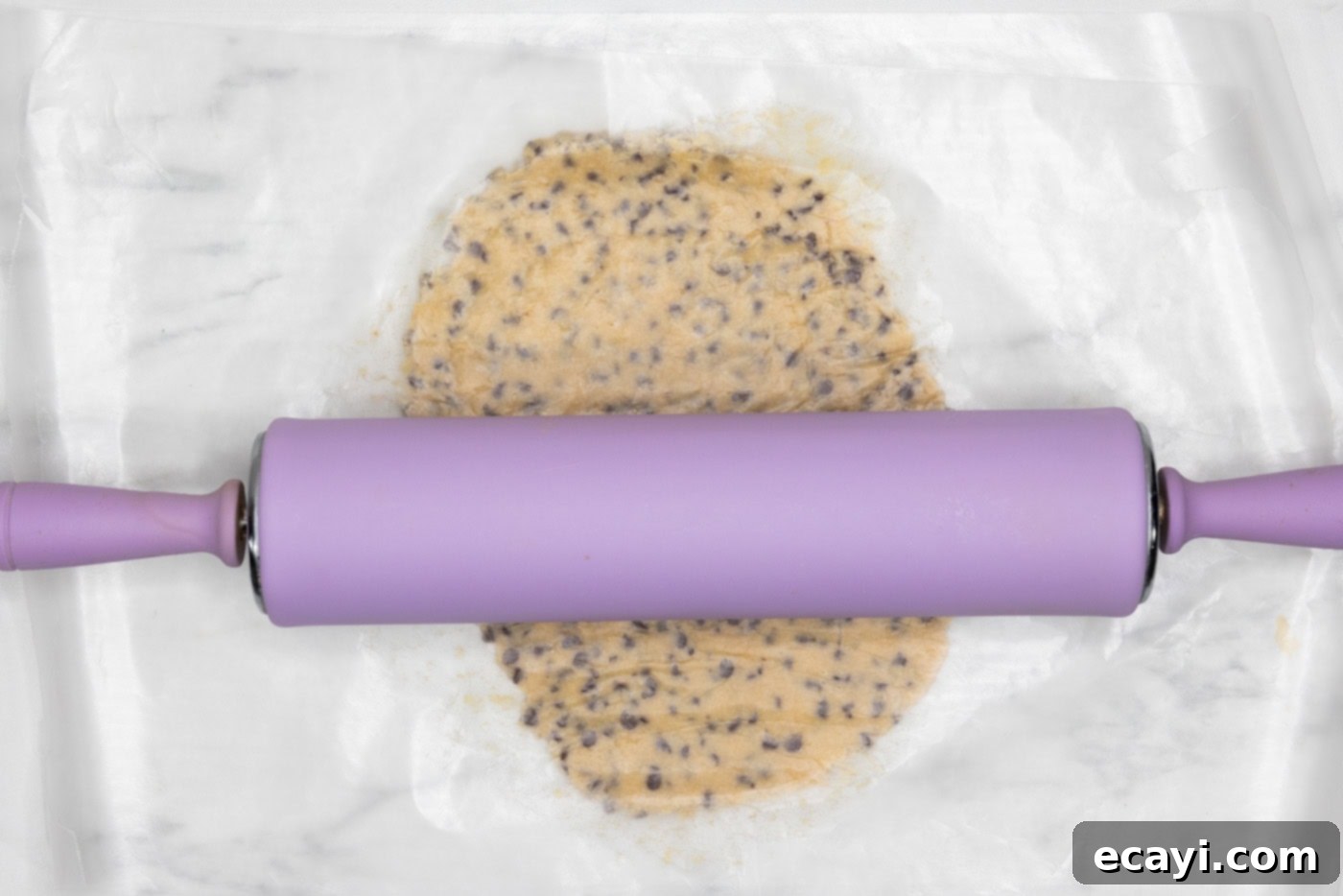 Chocolate Chip Cookie Mountain 8 rolling pin flattening cookie dough ball between parchment paper