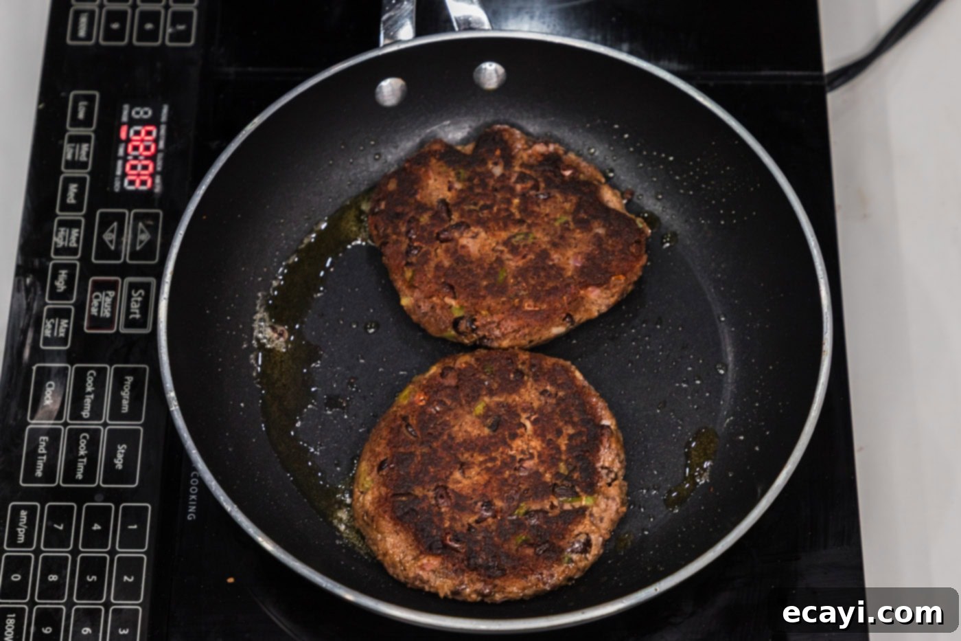 Signature Black Bean Burger 12 cooked black bean burgers in a skillet