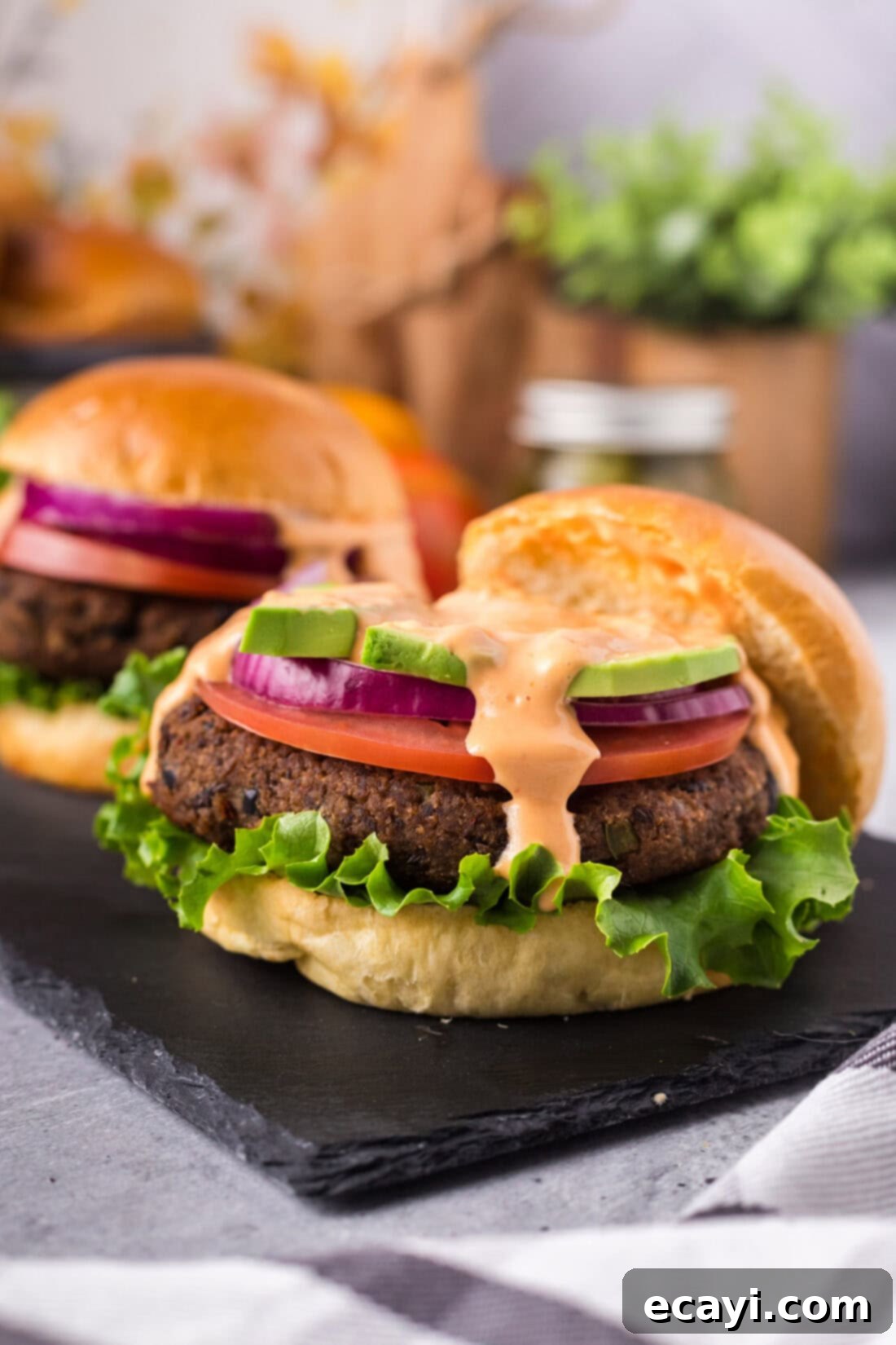 Signature Black Bean Burger 13 Close up photo of a Black Bean Burger with the top bun removed