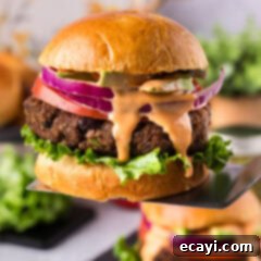 Signature Black Bean Burger 14 Black Bean Burger lifted up on a spatula