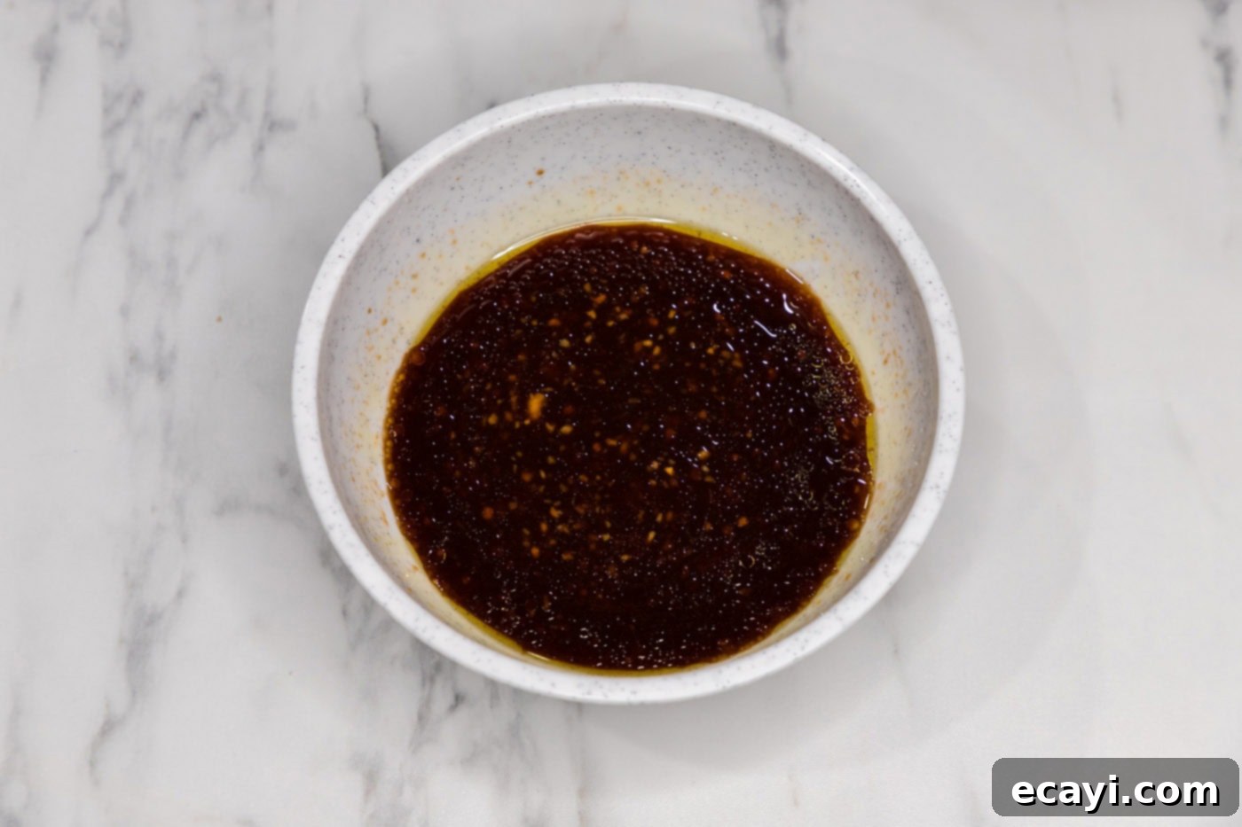 Bourbon Glazed Instant Pot Chicken 5 Homemade bourbon chicken sauce whisked in a bowl, featuring a blend of sweet and savory flavors.