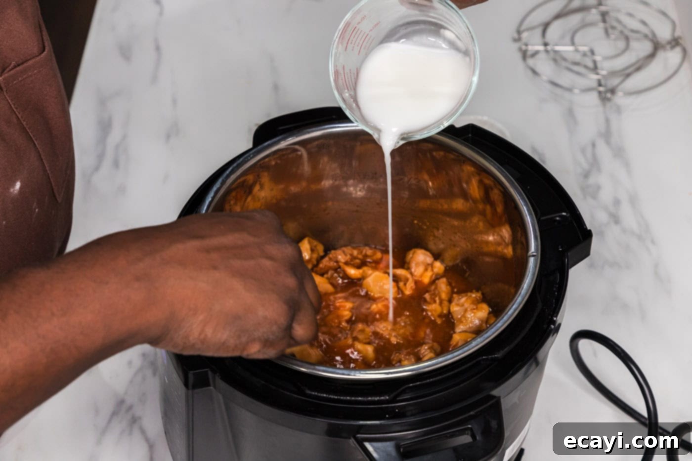 Bourbon Glazed Instant Pot Chicken 7 Thickening the Instant Pot Bourbon Chicken sauce with a cornstarch slurry for perfect consistency.