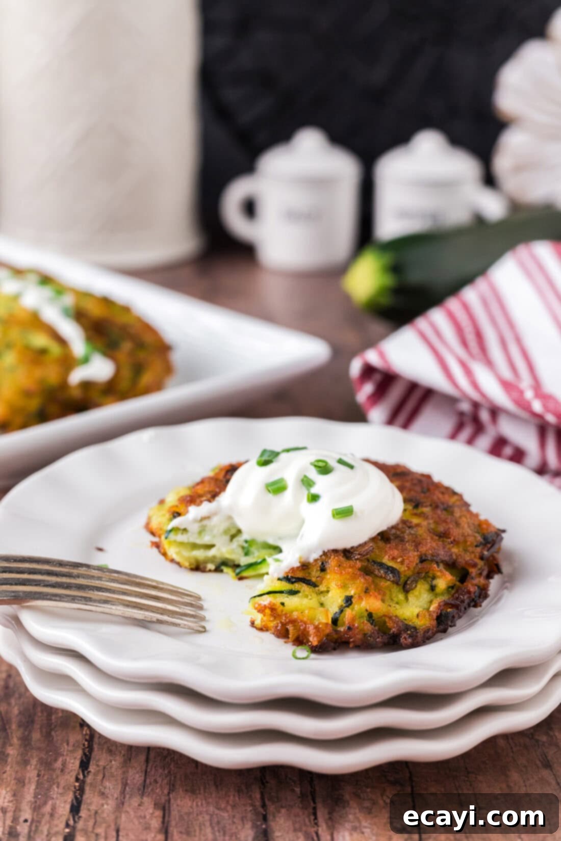 Crispy Zucchini Delights 12 Zucchini Fritter on a plate with a piece removed