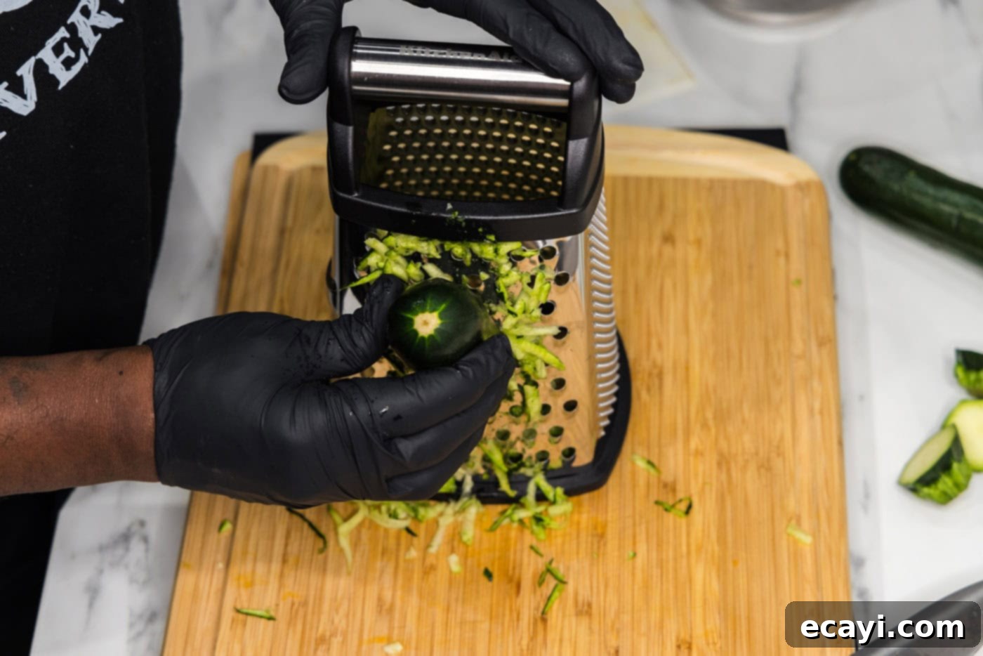 Crispy Zucchini Delights 5 shredding zucchini on a box grater