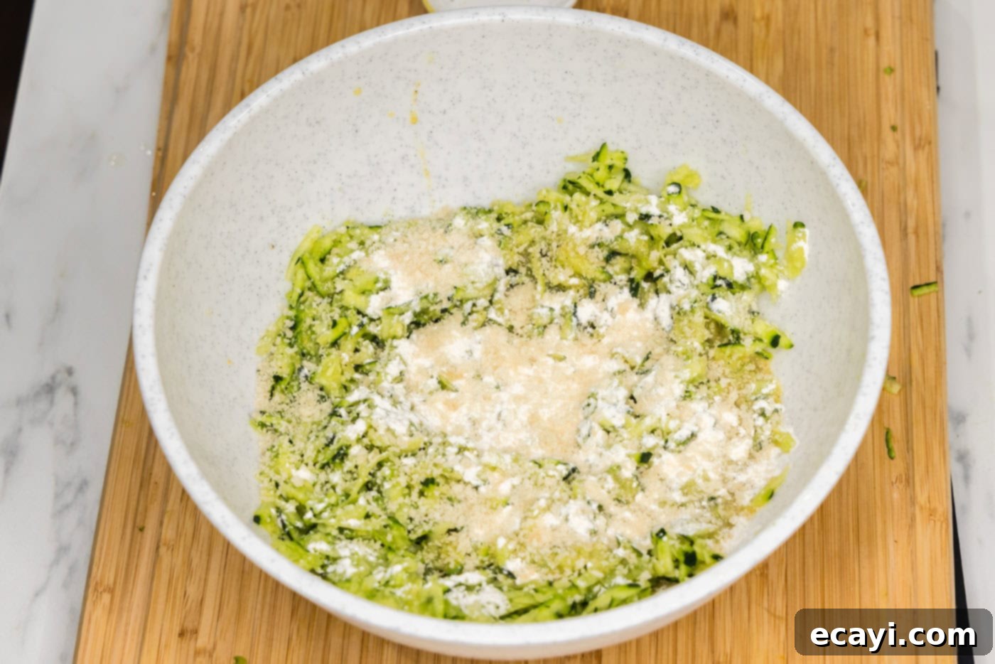 Crispy Zucchini Delights 8 flour and breadcrumbs added to shredded zucchini mixture in a bowl