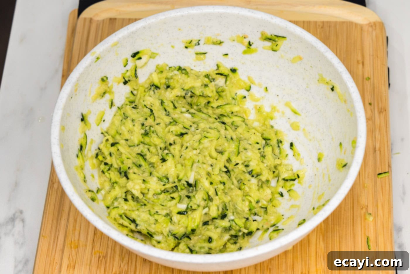 Crispy Zucchini Delights 9 zucchini fritter mixture in a bowl