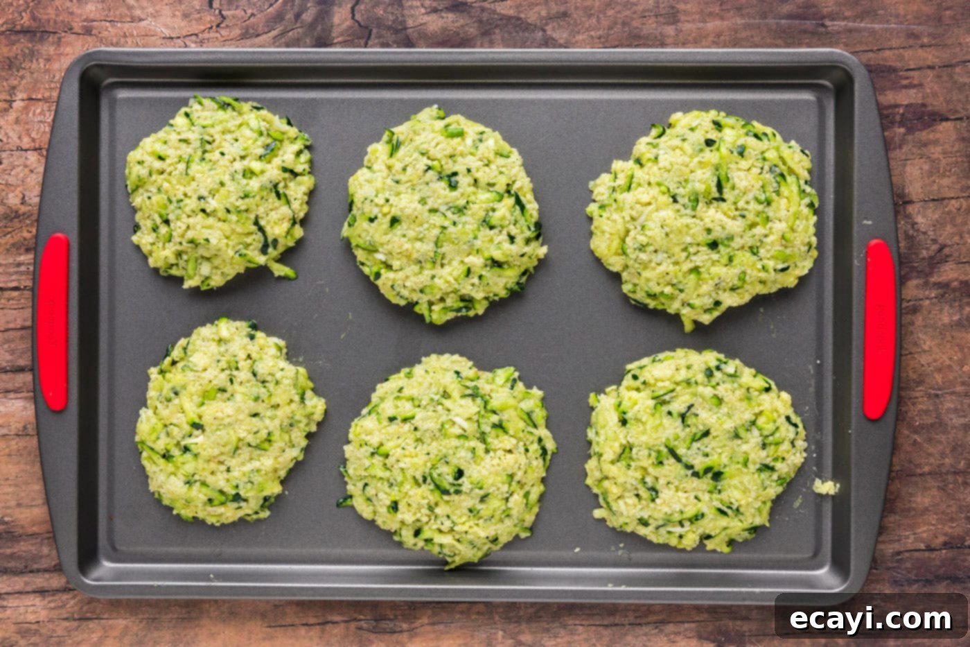 Crispy Zucchini Delights 10 zucchini fritters on a baking sheet