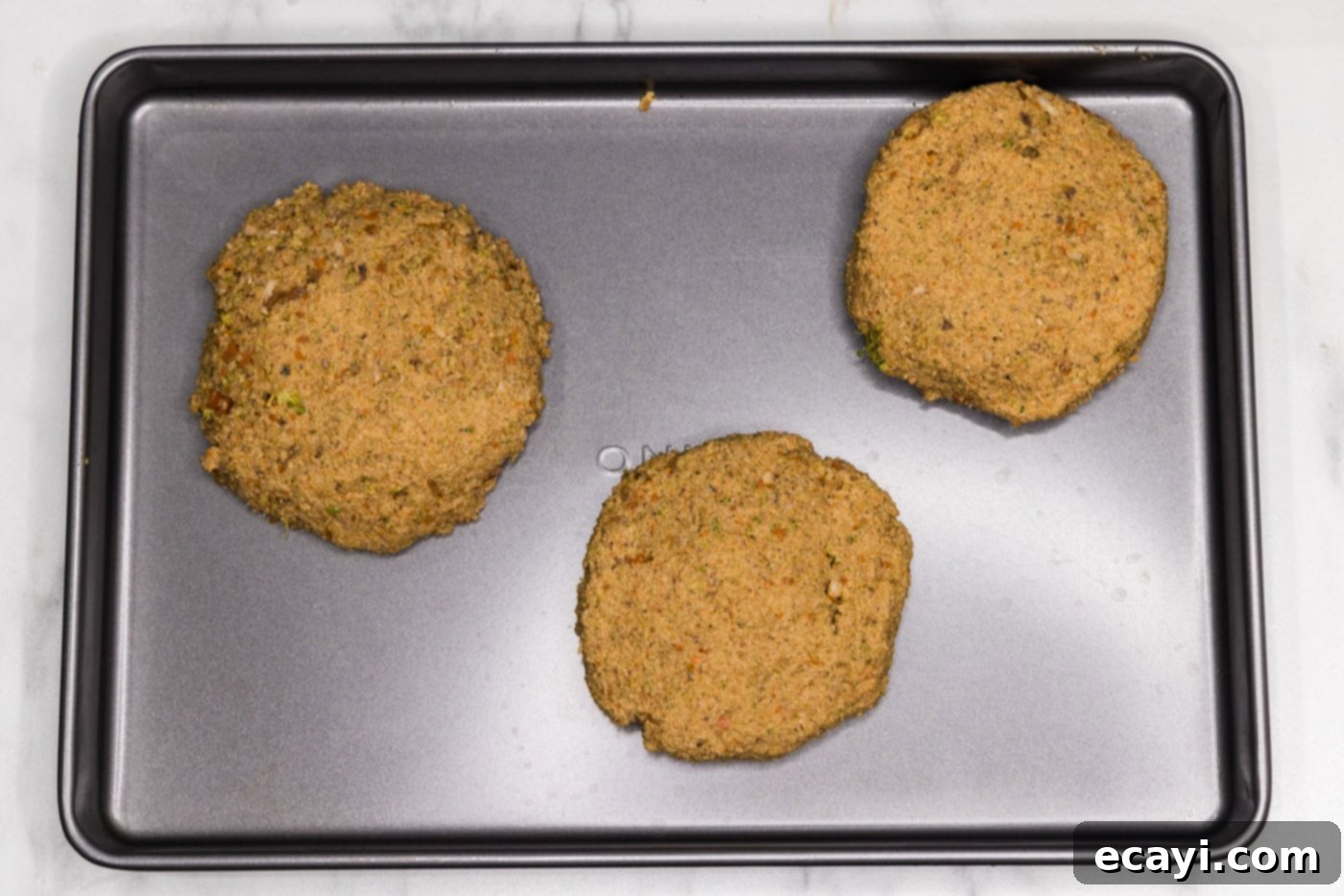 Plant-Based Burgers 12 veggie burger patties on a baking sheet
