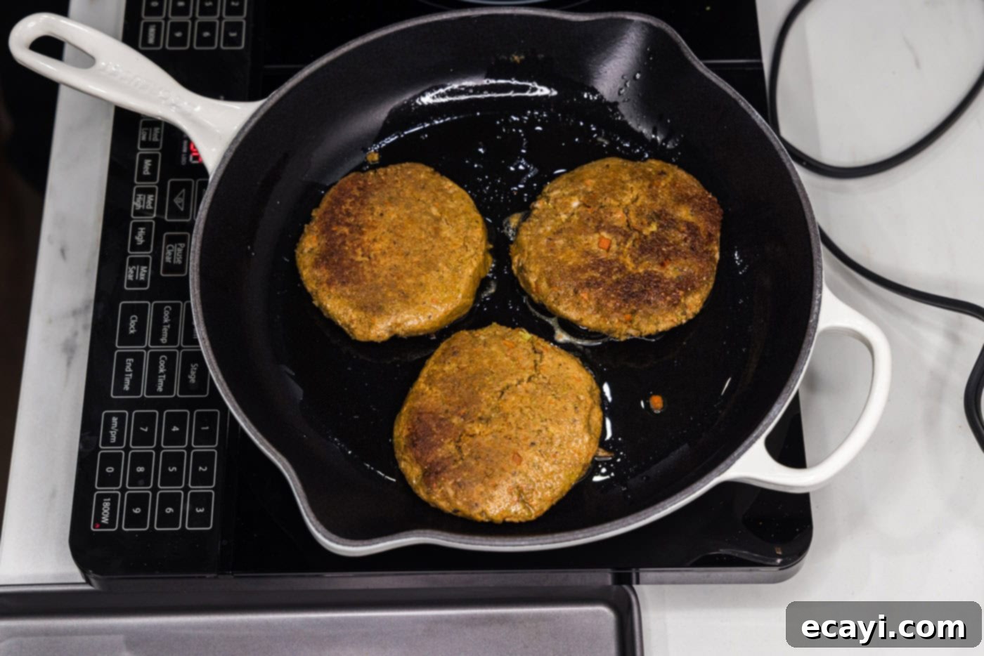 Plant-Based Burgers 13 cooking veggie burger patties in a skillet
