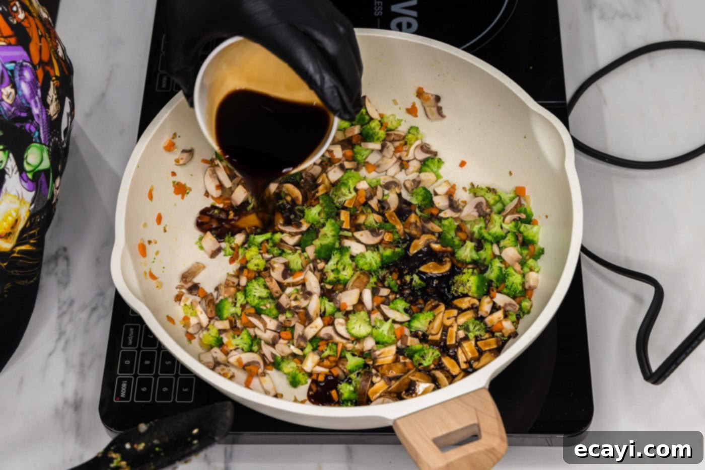Plant-Based Burgers 6 pouring soy sauce into skillet with chopped vegetables