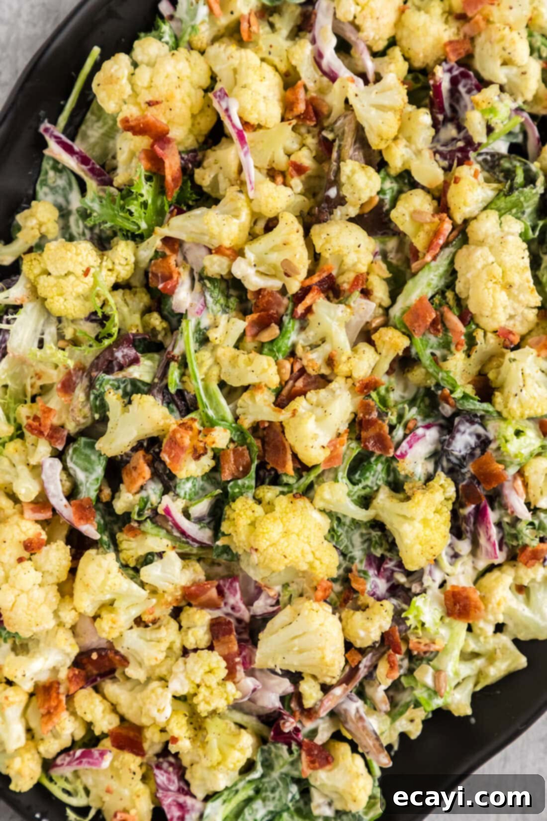 Zesty Cauliflower Medley 3 Close up photo of Creamy Roasted Cauliflower Salad, highlighting the textures and vibrant colors.