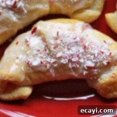 Festive White Chocolate Candy Cane Cookies 12 A close up of a white chocolate candy cane crescent, showcasing its delicious texture and festive appeal.