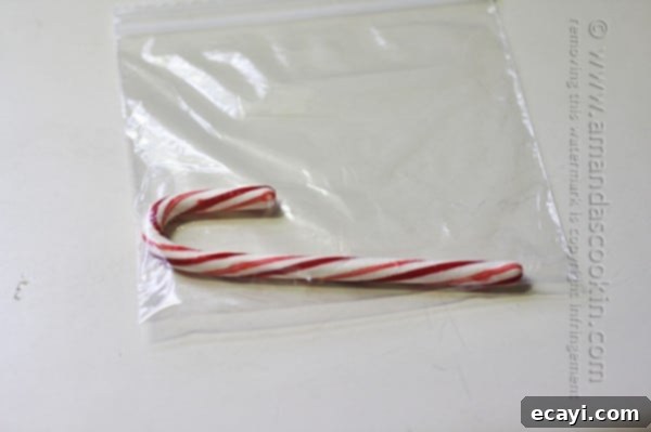 Festive White Chocolate Candy Cane Cookies 8 A single red and white striped candy cane securely sealed in a clear plastic zipper bag, ready to be crushed for the recipe.