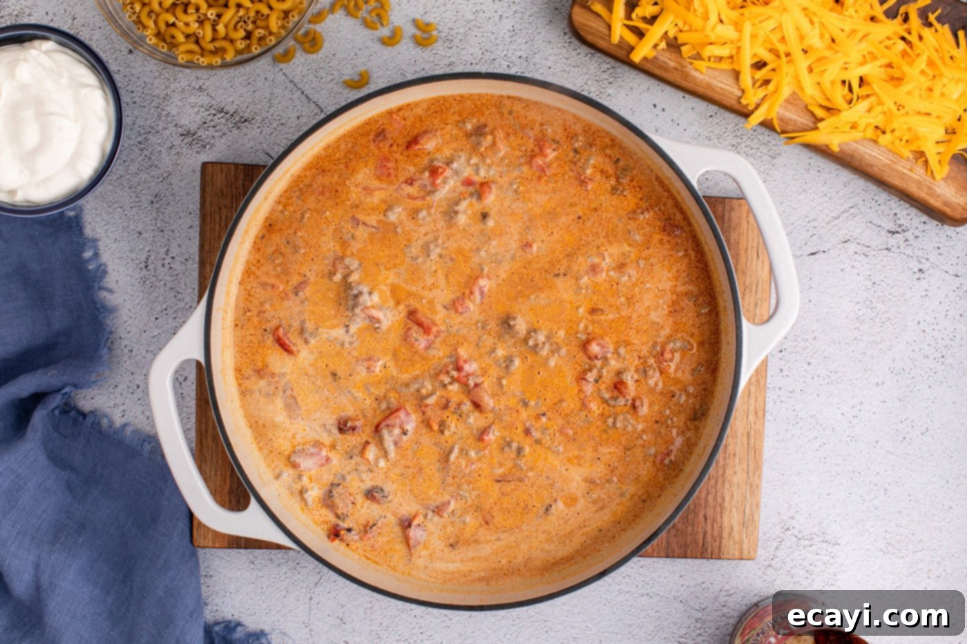 Taco Mac 'n' Cheese 7 taco macaroni and cheese mixture bubbling gently in a skillet after noodles have been added.