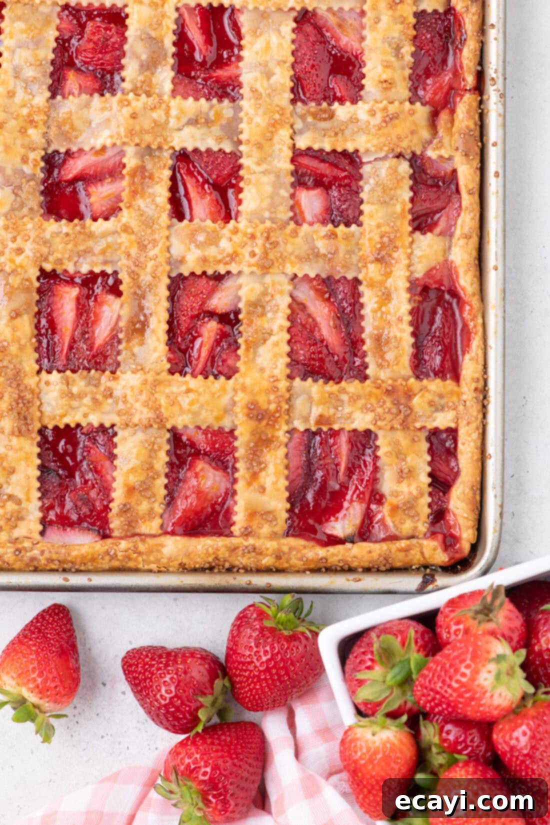 Strawberry Sheet Pan Delight 2 Overhead photo of a Strawberry Slab Pie, showcasing its beautiful lattice crust and vibrant filling.