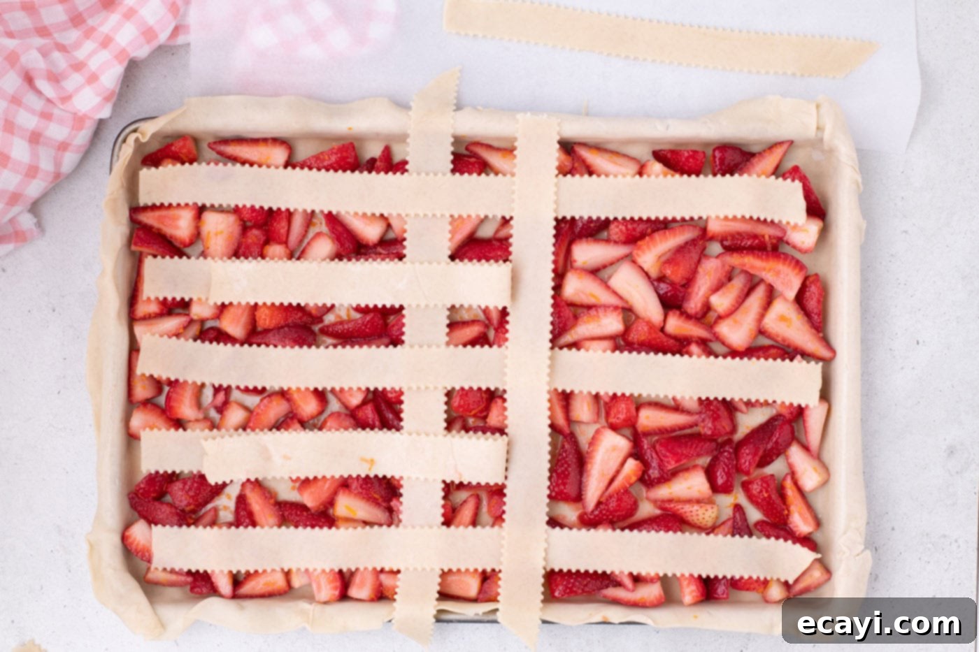 Strawberry Sheet Pan Delight 15 continuing to weave pie crust into a lattice top over strawberries