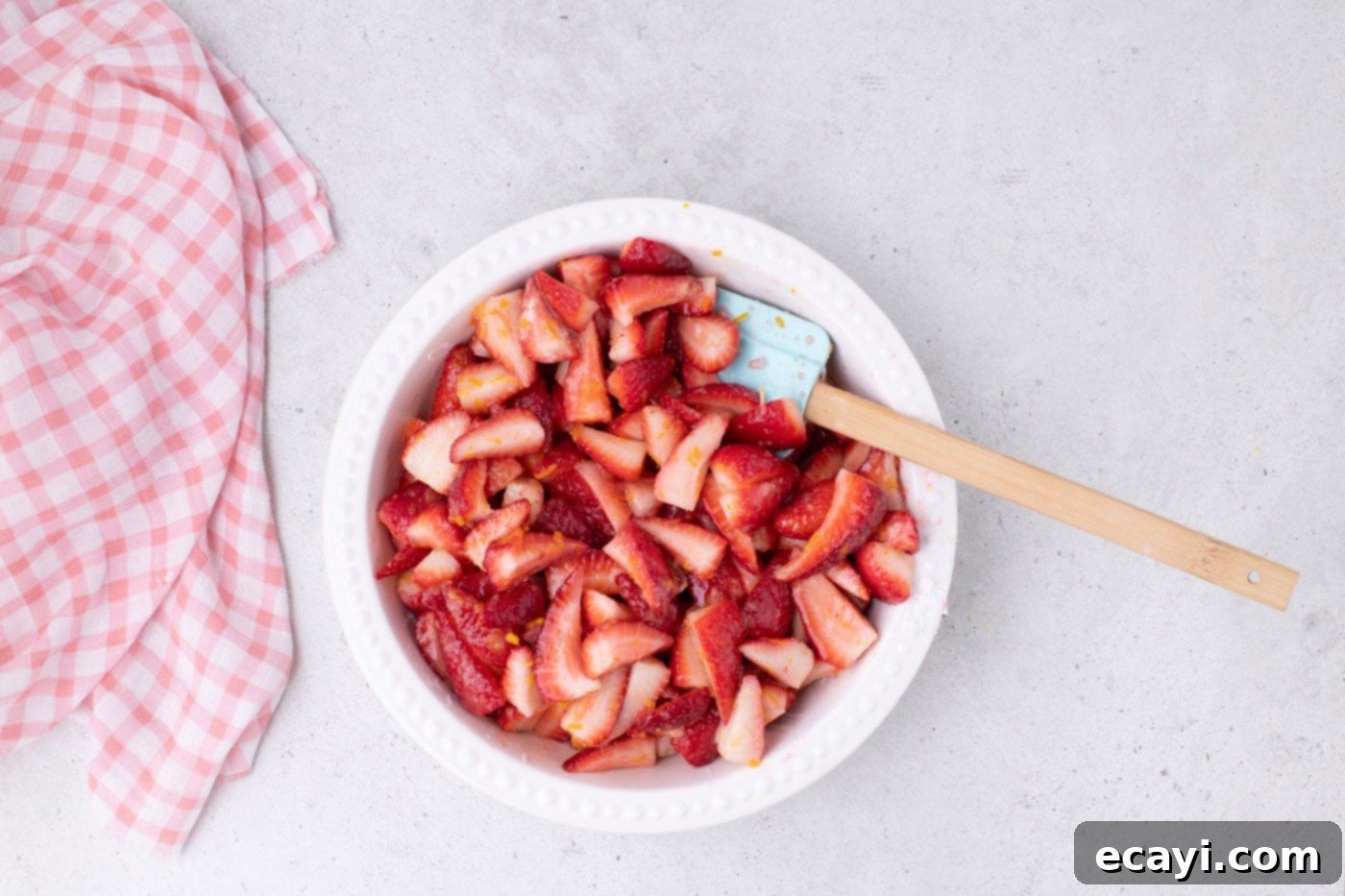 Strawberry Sheet Pan Delight 6 sliced strawberries in a bowl with sugar, cornstarch, and citrus zest, well combined