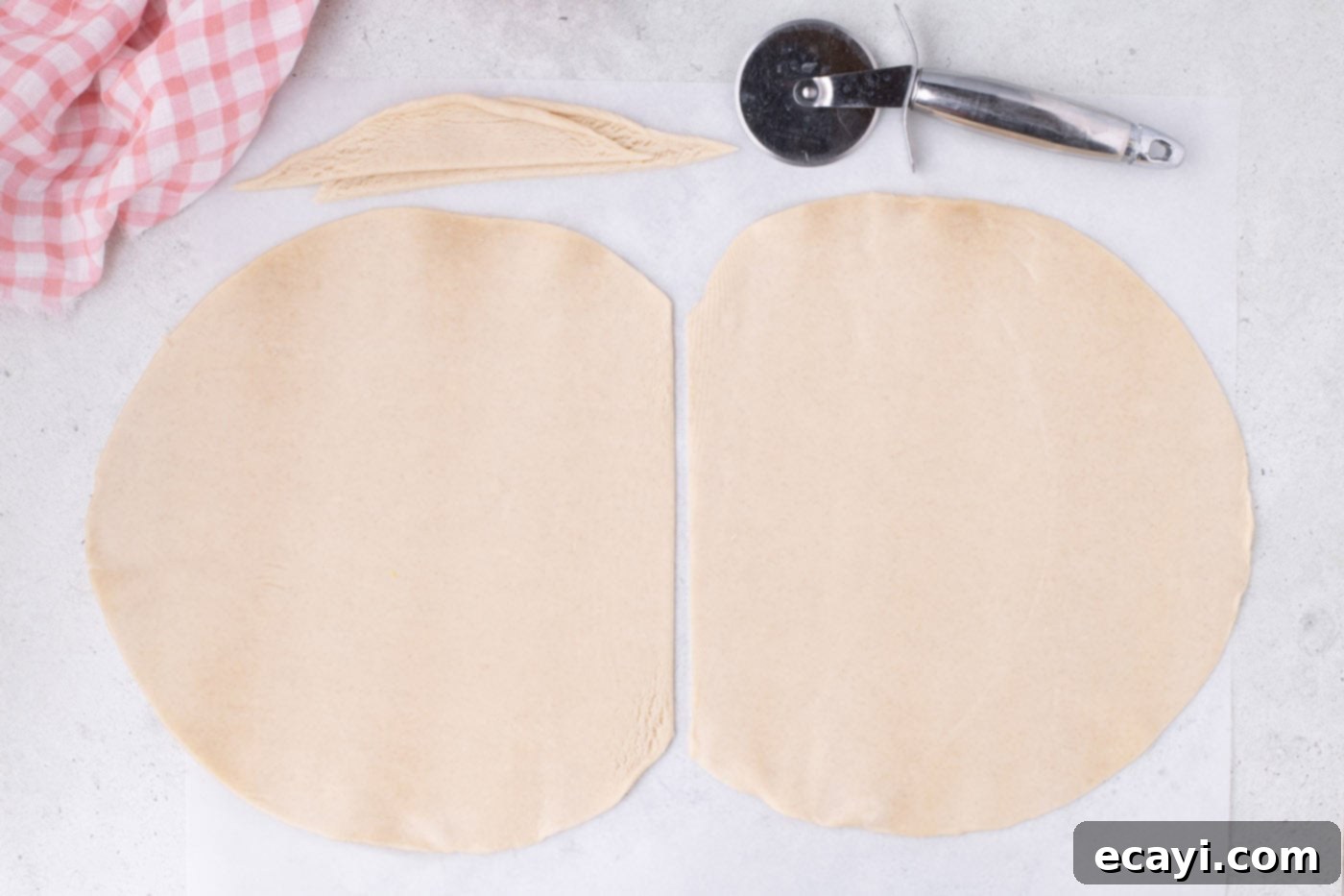 Strawberry Sheet Pan Delight 7 trimmed pie crusts laid out on a flat surface with parchment paper